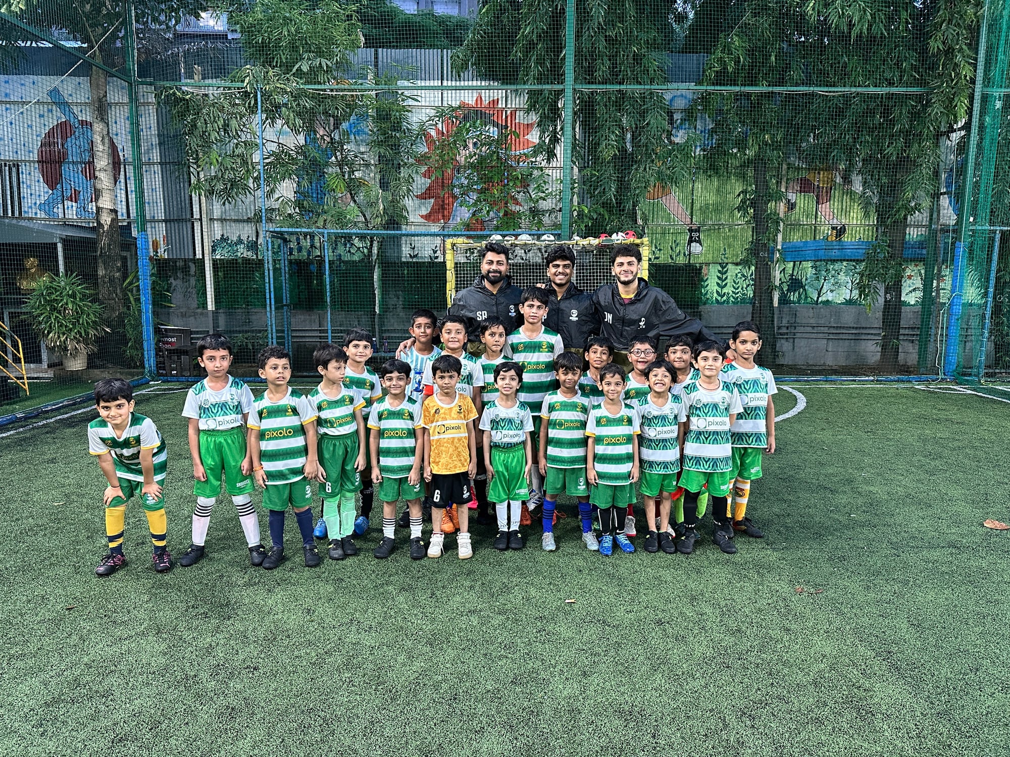 Football coaching team with young players at the best kids football academy in Ghatkopar since 2003